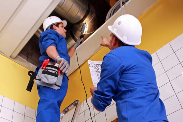 Two technicians working on installation