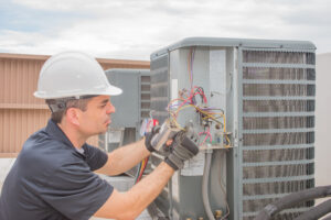 worker repairing air conditioner